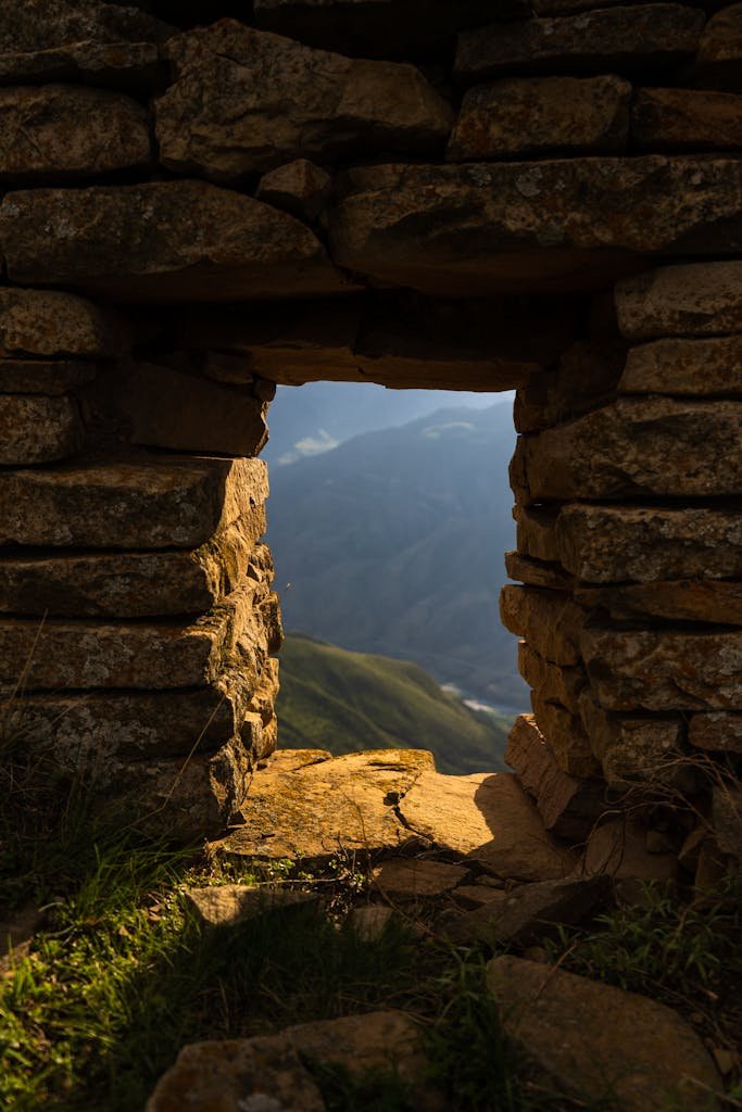Aged stone archway framing a scenic mountain view in Goor, Dagestan, Russia.