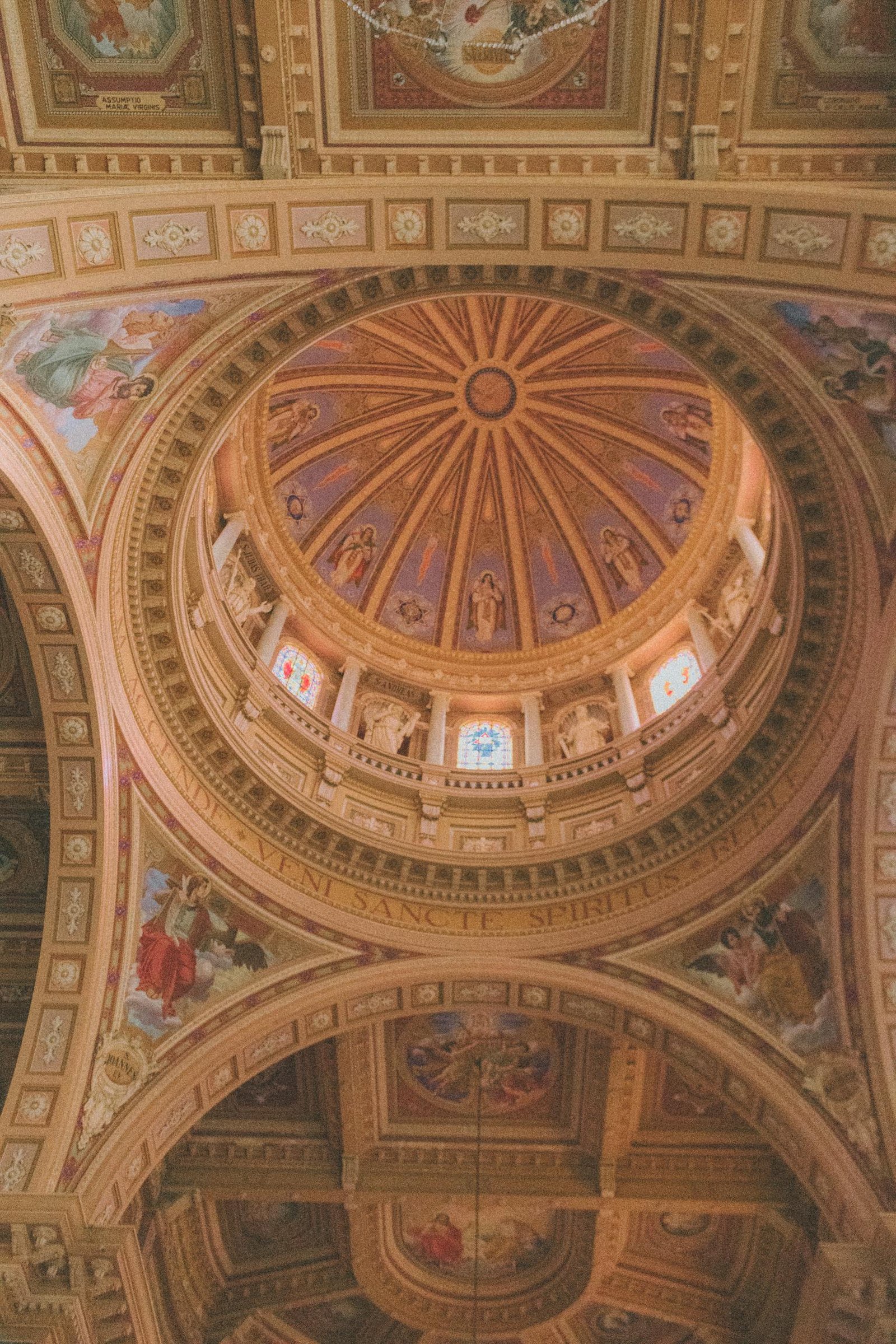 A beautifully detailed view of a cathedral ceiling with vibrant paintings and intricate designs.