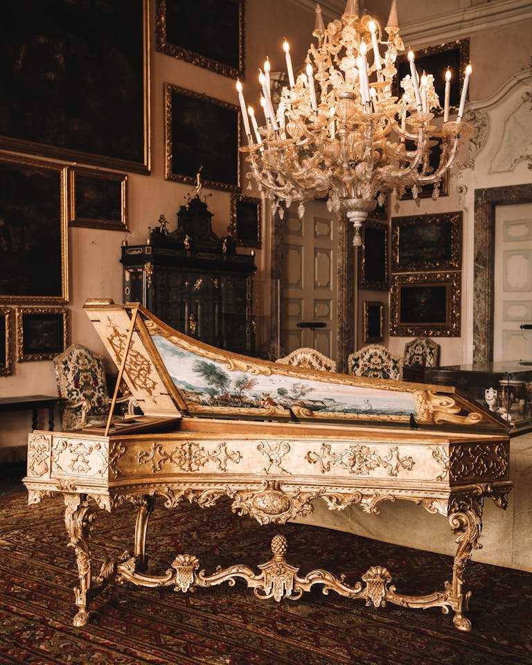 Elegant interior of Isola Bella's villa featuring ornate piano and chandelier in Stresa, Italy.