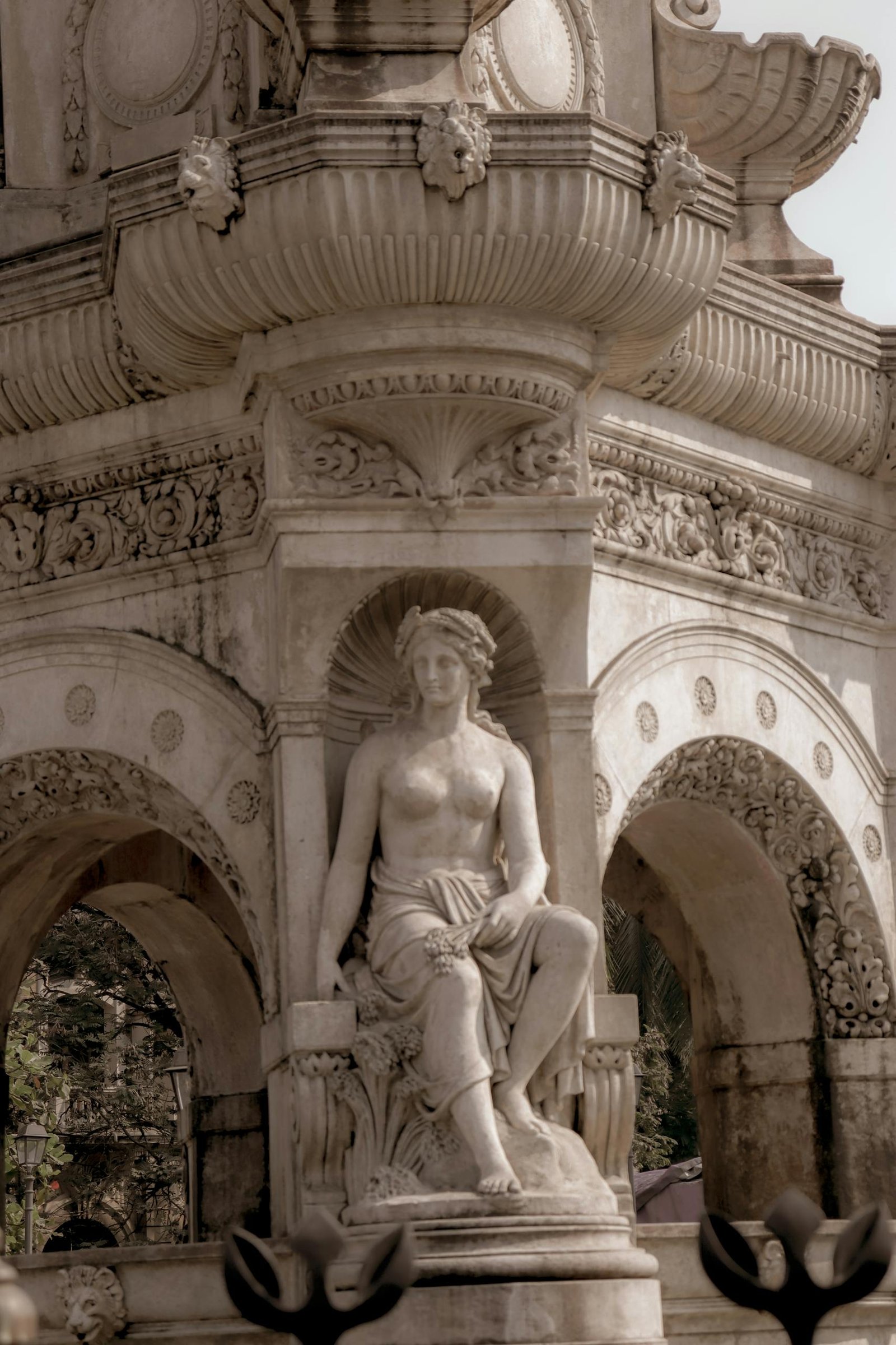Marble statue in detailed architectural setting, representing classical art.